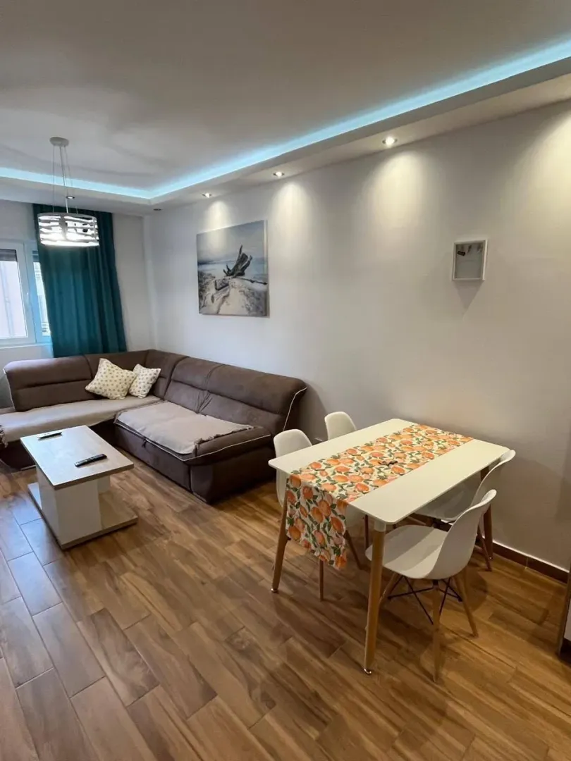 Living room with a sofa and a dining table.