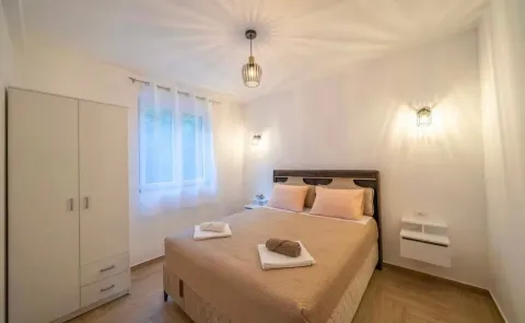 Bright bedroom with a double bed and a wardrobe. - image 8