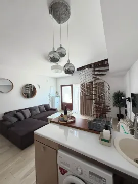 Modern living room with kitchen and spiral staircase. - image 2