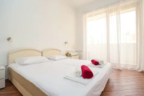 Bright bedroom with a large double bed and balcony access. - image 11