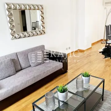 Living room with sofa and dining area. - image 7