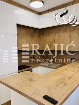 Modern kitchen with wooden elements and a bar counter. - image 4