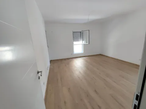 Empty unfurnished room with white walls and wooden flooring. - image 5