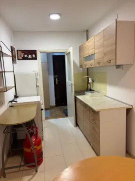 Smaller kitchen with wooden units and built-in appliance. - image 8