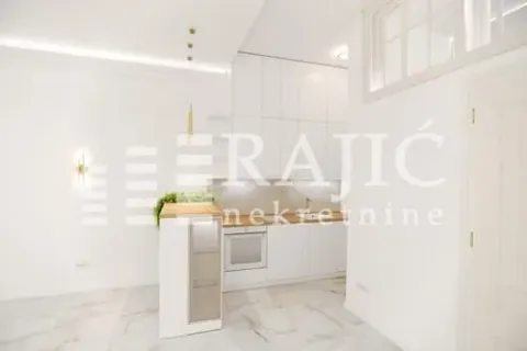 Modern white kitchen with a bar counter within a bright interior. - image 3