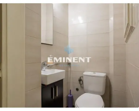 Smaller tiled bathroom with a sink and a toilet. - image 13