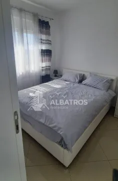 Bedroom with a double bed and a window with curtains. - image 7