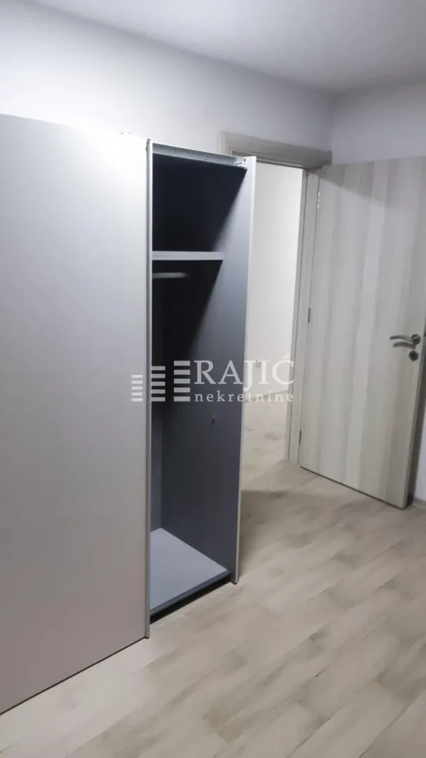 Room with a built-in wardrobe and wooden flooring.