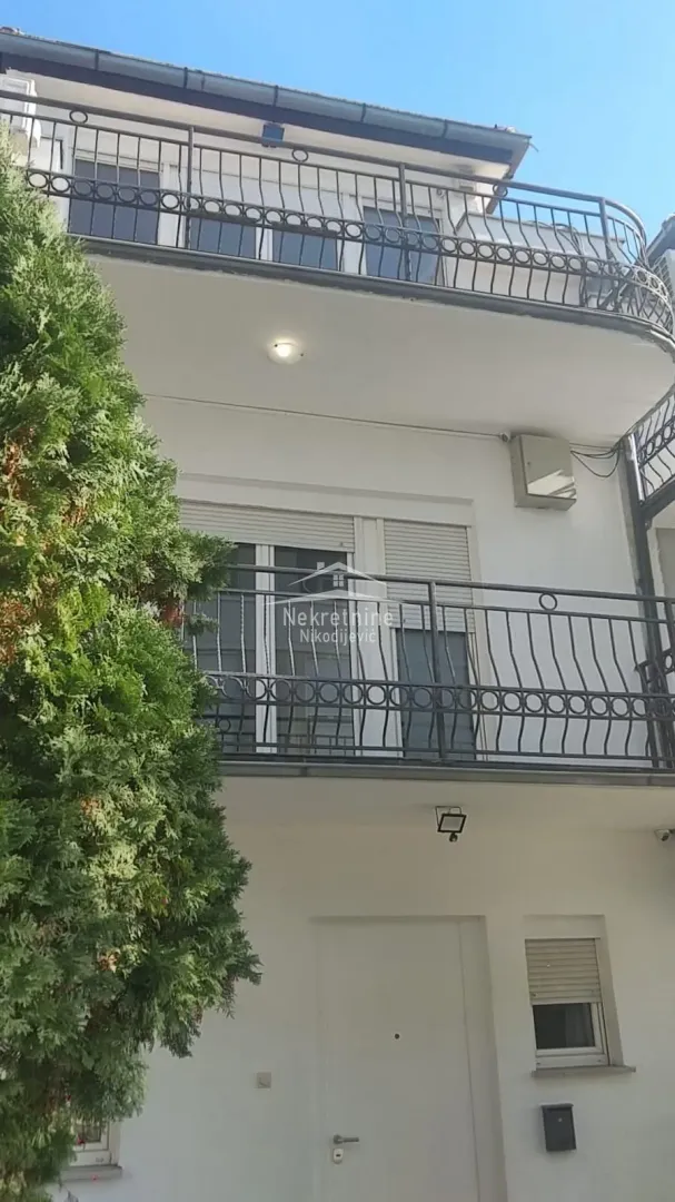 View of the exterior of the building with balconies and entrance.