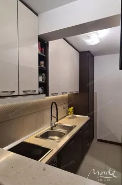 Small kitchen with white and dark cabinets and a sink. - image 7