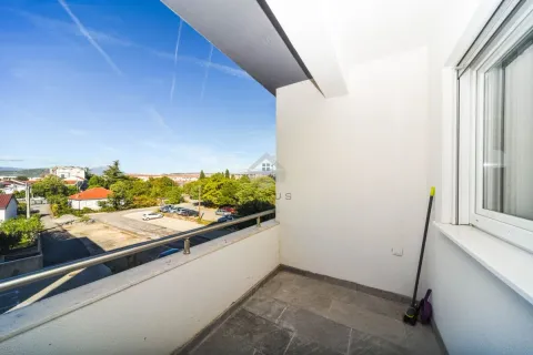 Small bright balcony overlooking the neighborhood and parking lot. - image 4