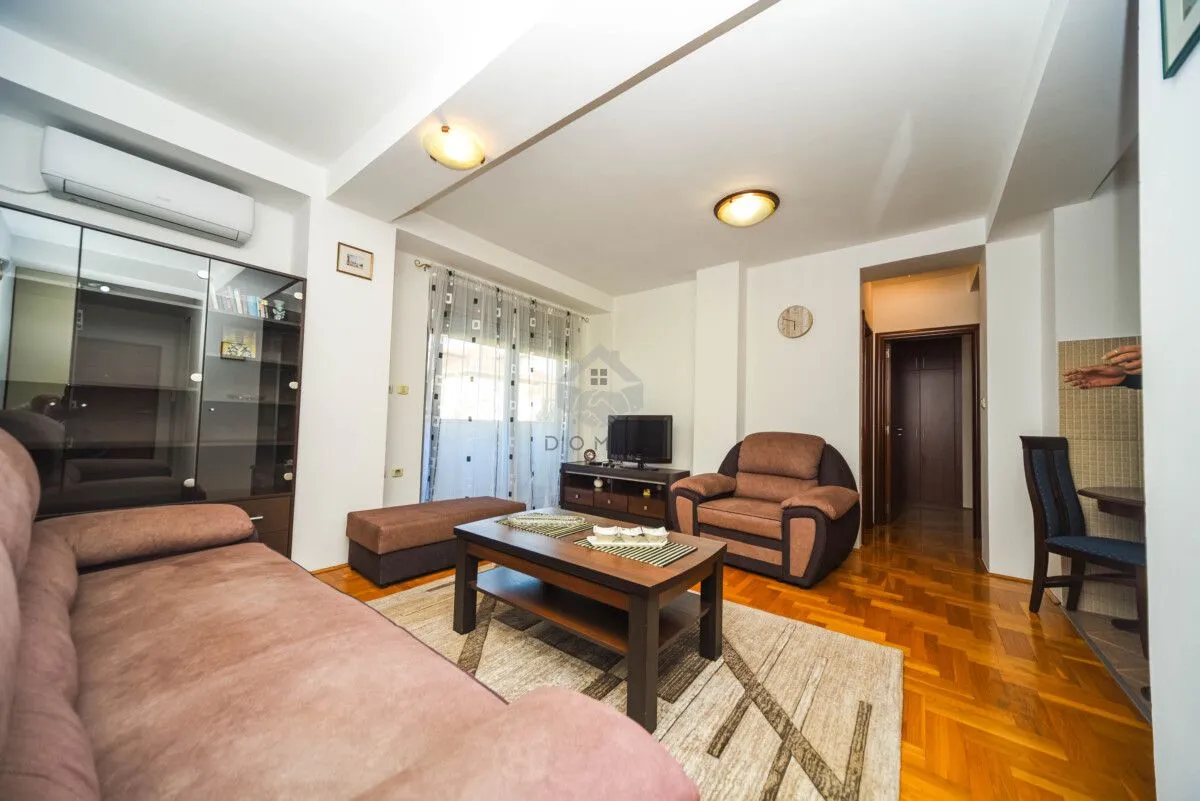 Living room with sofa set, coffee table, and TV.