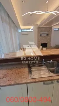 View from the kitchen with countertop and sink towards the living room and dining area. - image 5