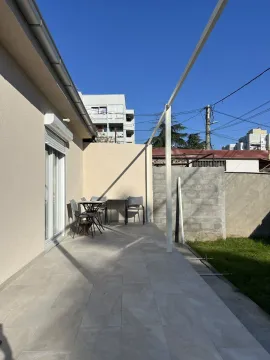 A paved terrace with a seating set next to the house. - image 17