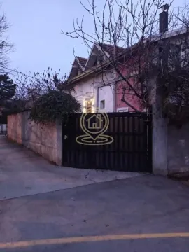 View of the exterior of the house with a courtyard gate and fence. - image 2