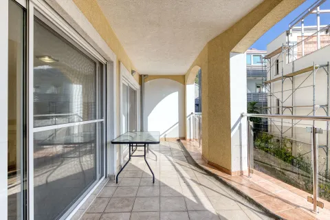 Covered balcony with ceramic tiles and glass railing. - image 11