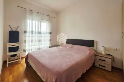 Bedroom with a double bed, nightstand, and a window with curtains. - image 7
