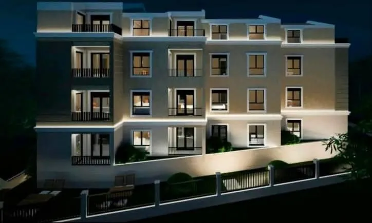 Night view of a modern residential building with lighting.
