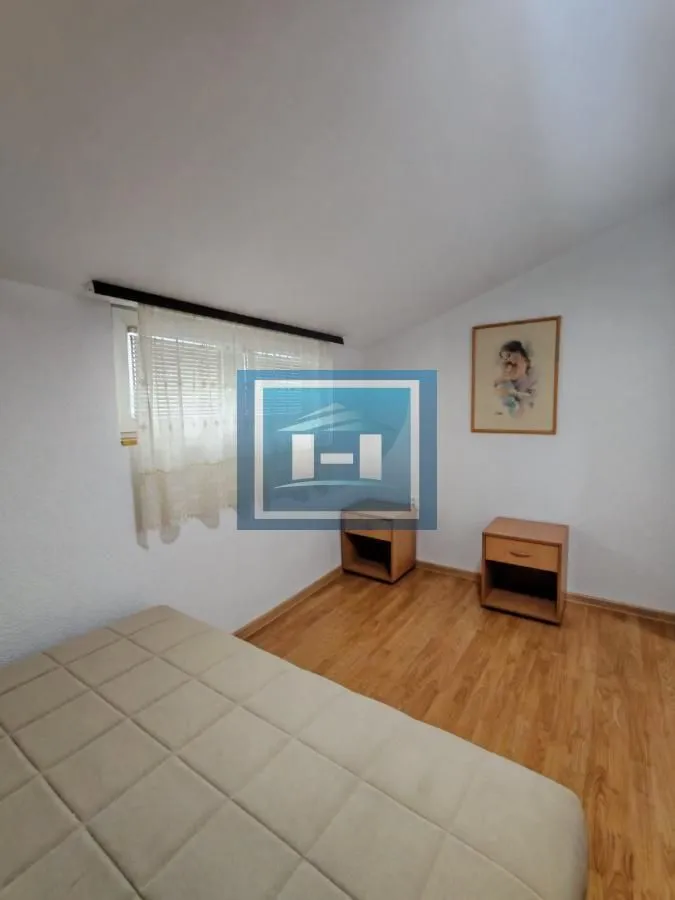 Smaller bedroom with a bed and bedside tables.