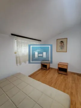 Smaller bedroom with a bed and bedside tables. - image 9