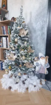 Christmas tree decorated with baubles and ornaments next to a bookshelf. - image 3