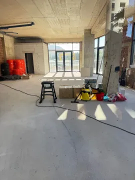 View of a spacious room under construction with building materials and tools. - image 6