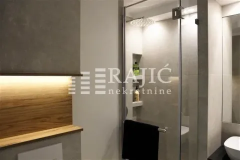 Modern bathroom with a walk-in shower. - image 9