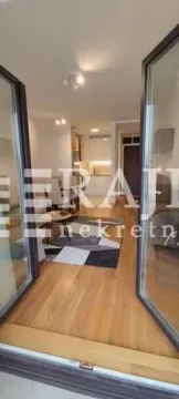View from the doorway towards the living room and dining area with hardwood flooring. - image 7