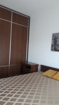 Furnished bedroom with a double bed, wardrobe, and a nightstand. - image 5