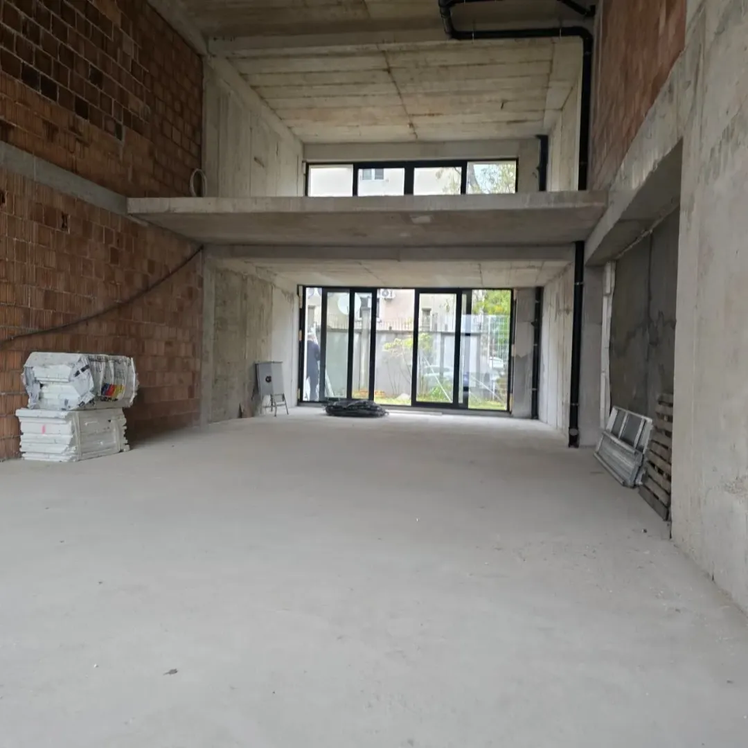 View of an unfinished interior space in grey phase with a gallery.