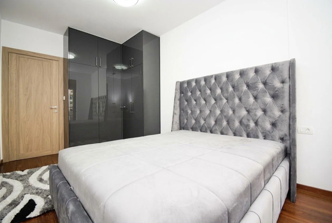 Modern bedroom with a double bed and a fitted wardrobe.