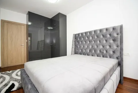 Modern bedroom with a double bed and a fitted wardrobe. - image 6