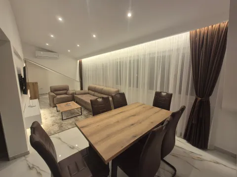Living room with a dining table and seating furniture. - image 4