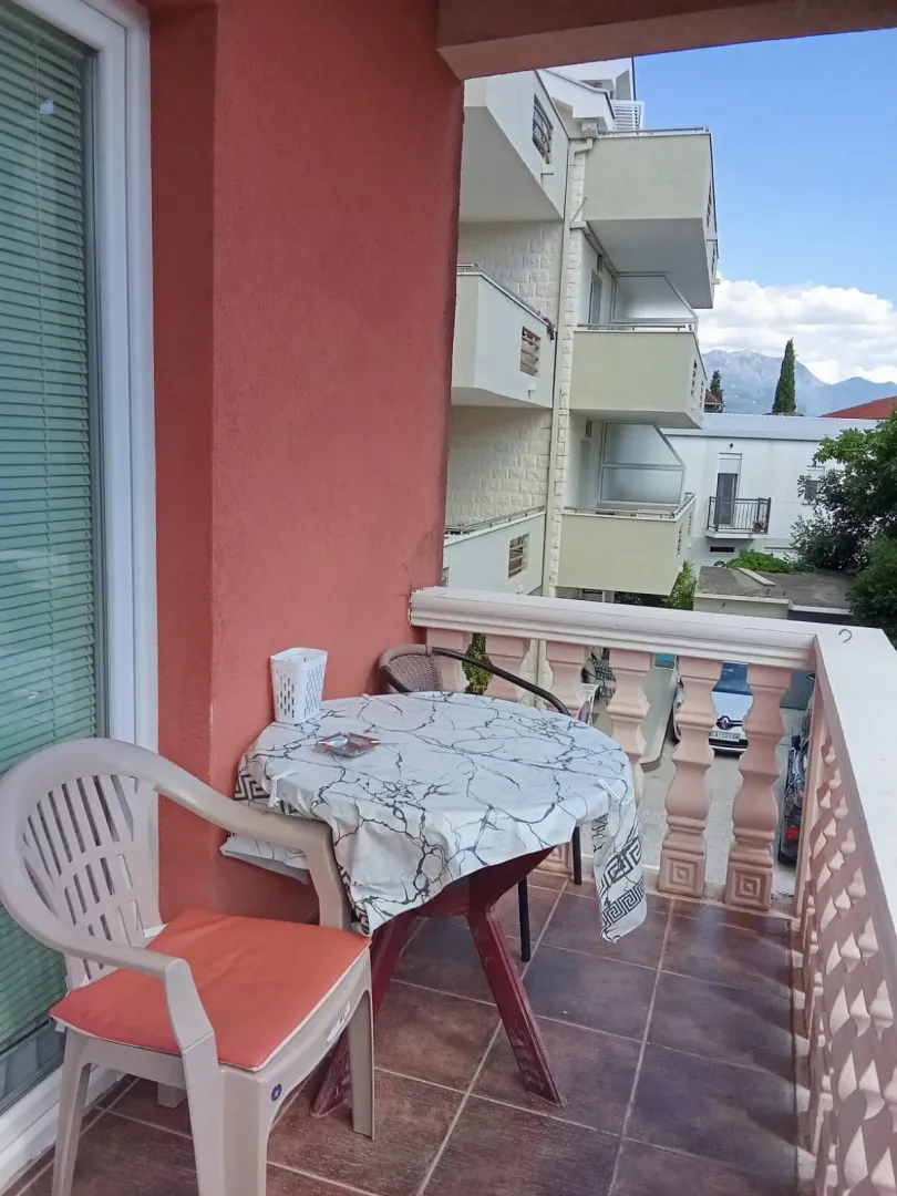 Manji namješteni balkon sa stolom i stolicama.