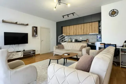 Spacious living room with seating area, TV, and kitchen in the background. - image 3