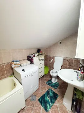 Manje kupatilo sa kadom, toaletom, umivaonikom i mašinom za veš pod kosim krovom. - image 14