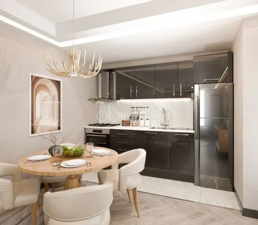 Modern kitchen with a dining area and built-in appliances.