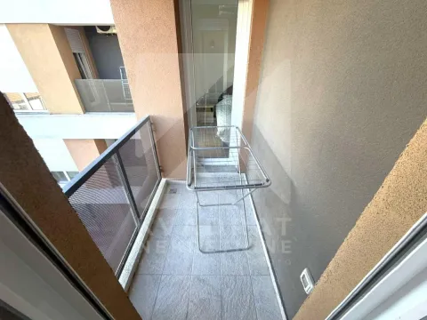 Small tiled balcony with a clothes drying rack. - image 2