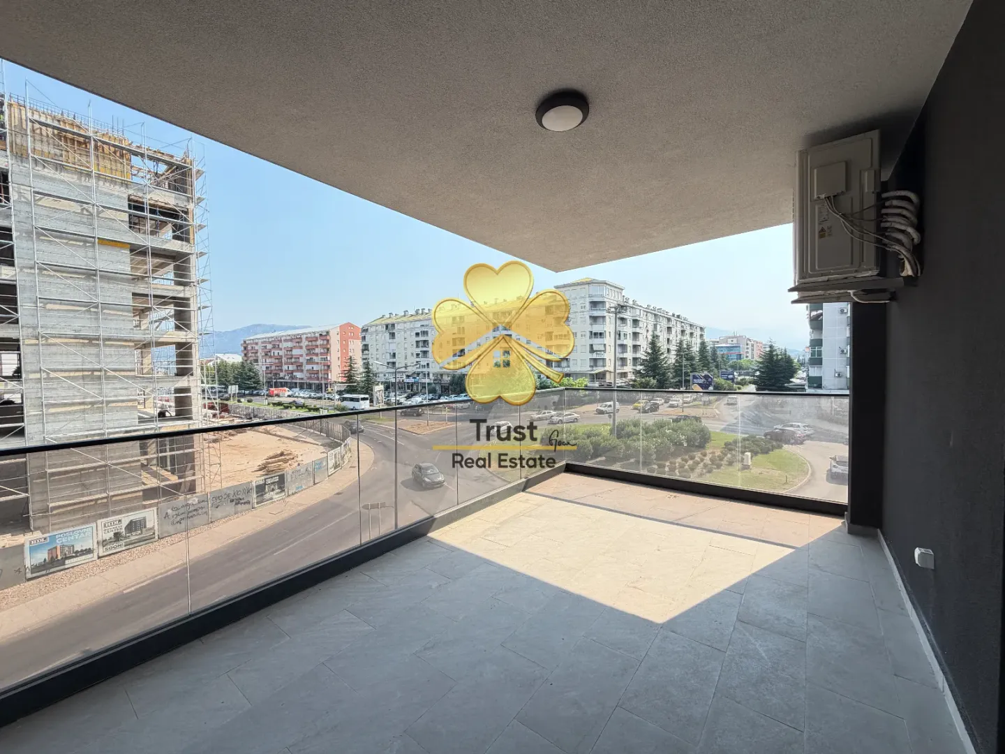 Spacious covered terrace with a view of the street and surrounding buildings.
