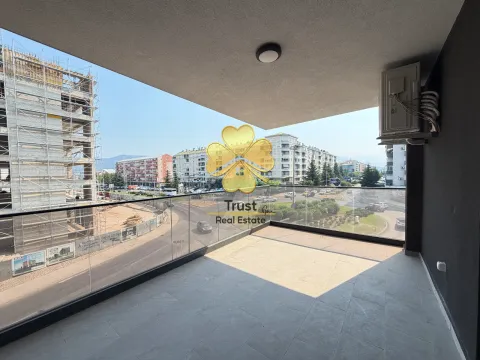 Spacious covered terrace with a view of the street and surrounding buildings. - image 3