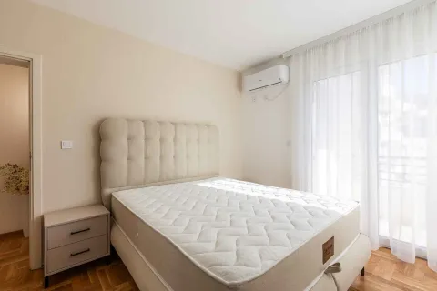Spavaća soba sa bračnim krevetom, noćnim stočićem i klima uređajem. - image 2