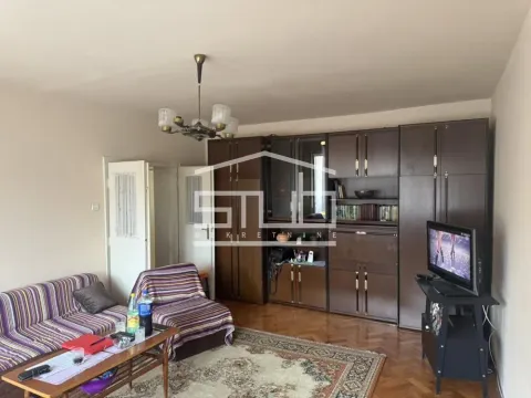 Living room with a sofa set, large wooden wardrobe, and a television. - image 9