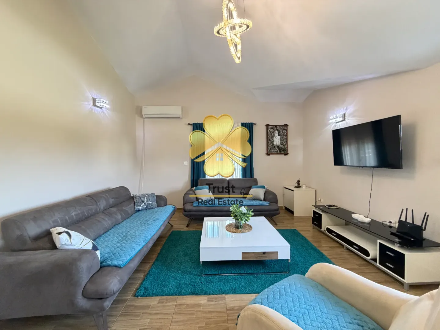Spacious living room with a seating set and a television.