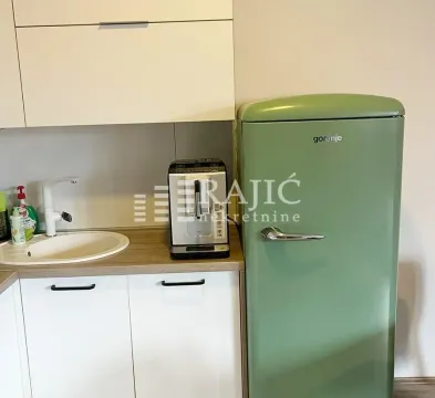 Part of the kitchen with a sink, coffee machine, and green refrigerator. - image 6