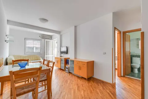 Living room with a dining area and parquet flooring. - image 3