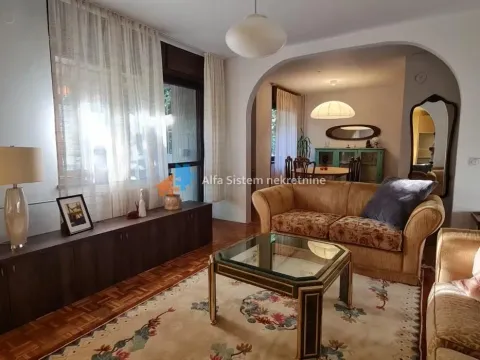 Spacious living room with seating set and a view of the dining area. - image 2