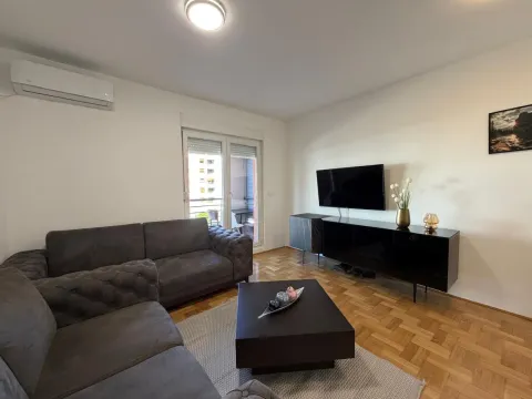 Living room with a sofa set, TV unit, and access to the terrace. - image 5