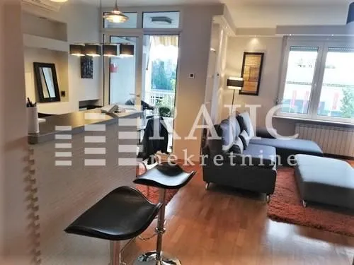 Living room connected with a bar counter and kitchen.