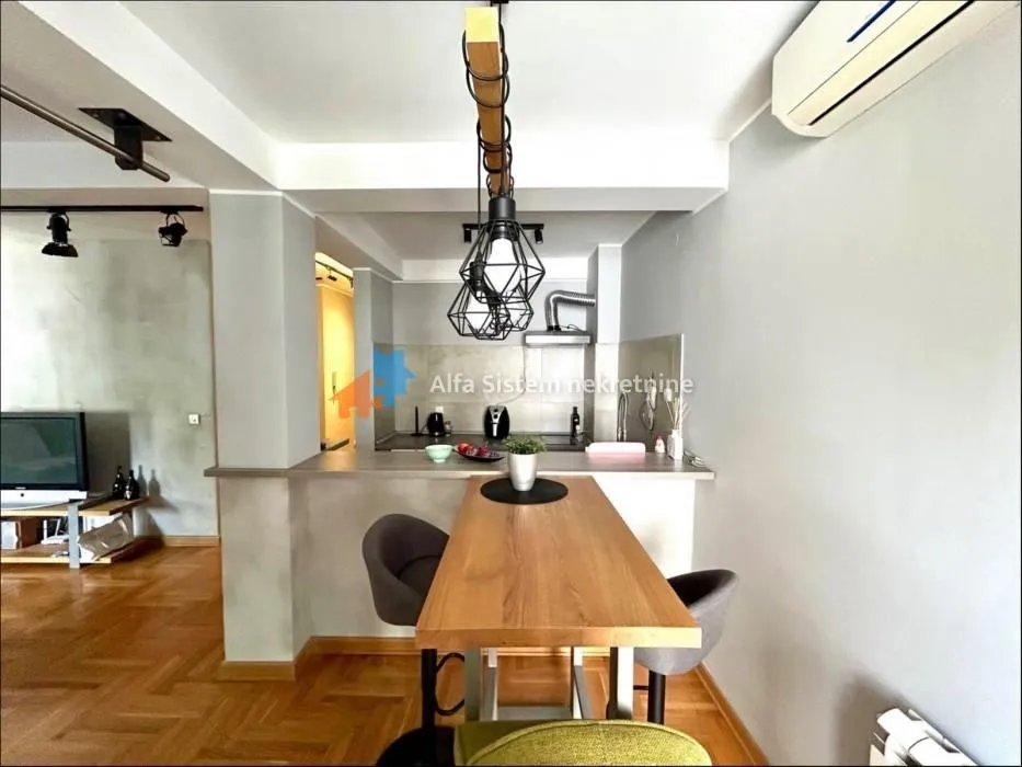 Kitchen with a bar counter and dining table.
