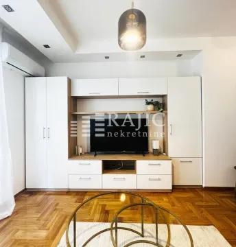 Living room with a TV unit and wooden flooring. - image 2